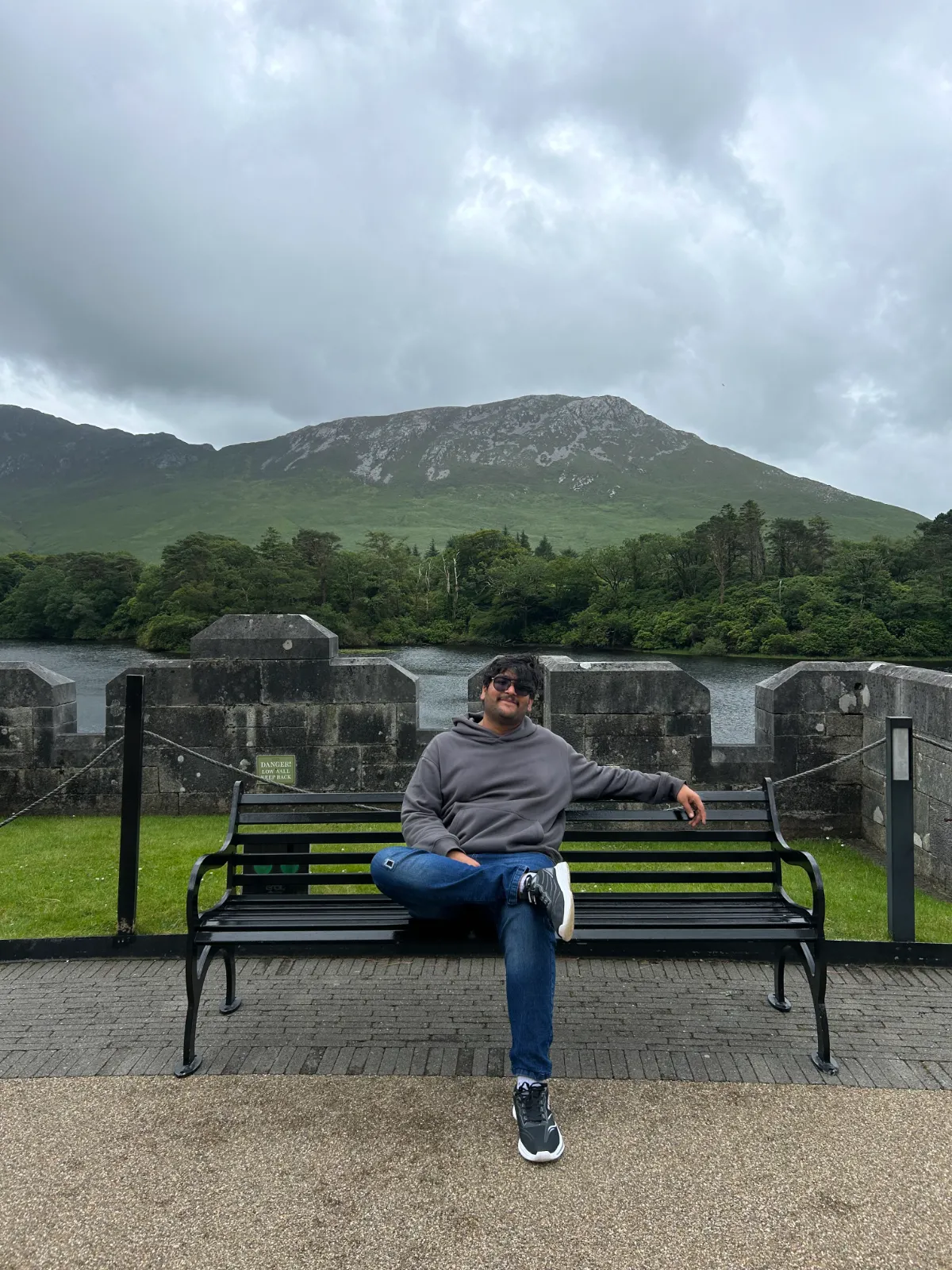 Anirudh Chugh seated on a lakeside bench in Ireland